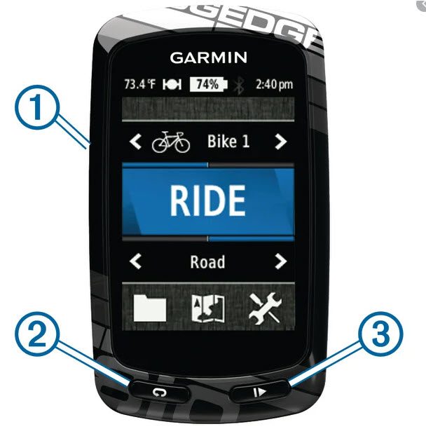 A Garmin Edge cycling computer with a screen displaying "Bike 1" and a blue "RIDE" button. The icons and buttons on the screen include indicators for temperature, battery level, and time. The device has physical buttons at the bottom and labeled features.