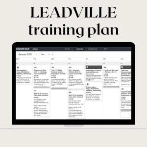 A laptop screen displays a January 2022 training plan schedule under the title "LEADVILLE training plan". It contains detailed day-by-day workout instructions organized in columns for each day of the week, including endurance runs and strength sessions.