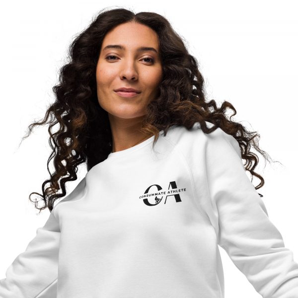 A person with long curly hair wears a white sweatshirt with a logo on the front left side that reads "CA Consummate Athlete" and a graphic of an athlete. The person is smiling and standing against a white background.
