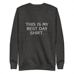 A dark gray sweatshirt with white text on the front that reads, "THIS IS MY REST DAY SHIRT." The sweatshirt has a simple crew neck design and long sleeves.