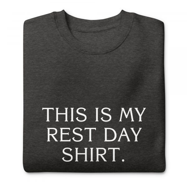 A folded dark gray t-shirt with the phrase "THIS IS MY REST DAY SHIRT." printed in white text on the front.