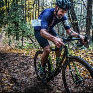 a man racing cyclocross in the mud